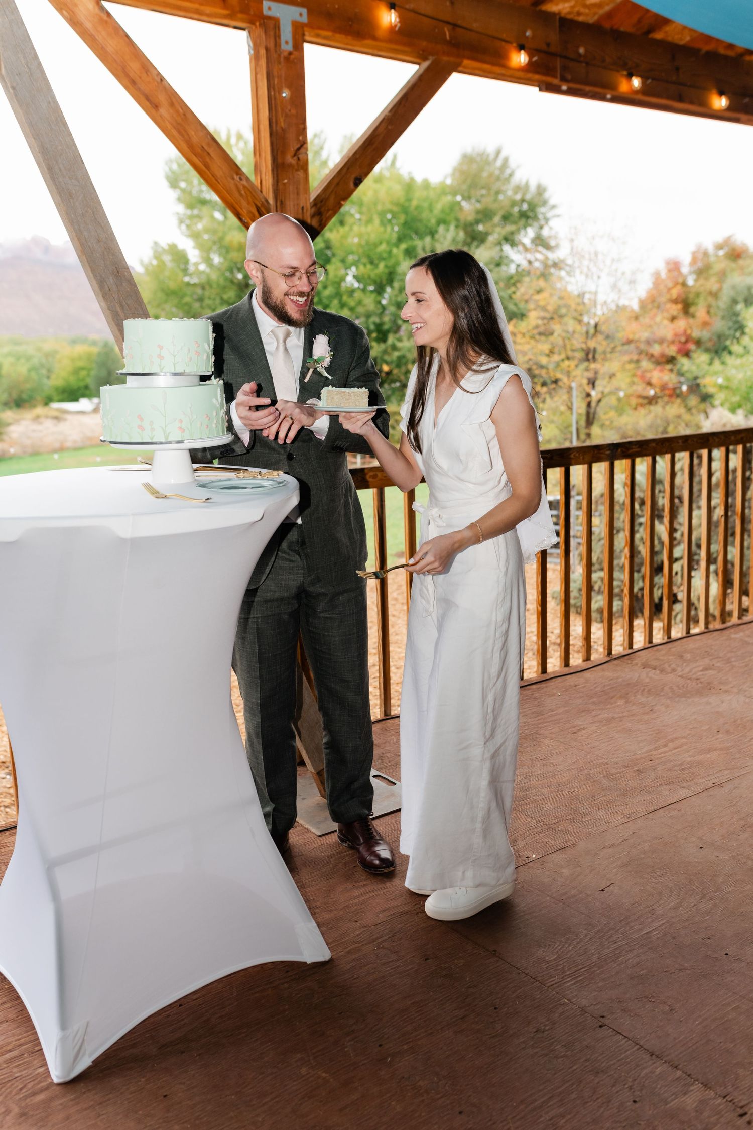 A playful sequence of dance moves between a couple on a covered wooden deck with string lights above.