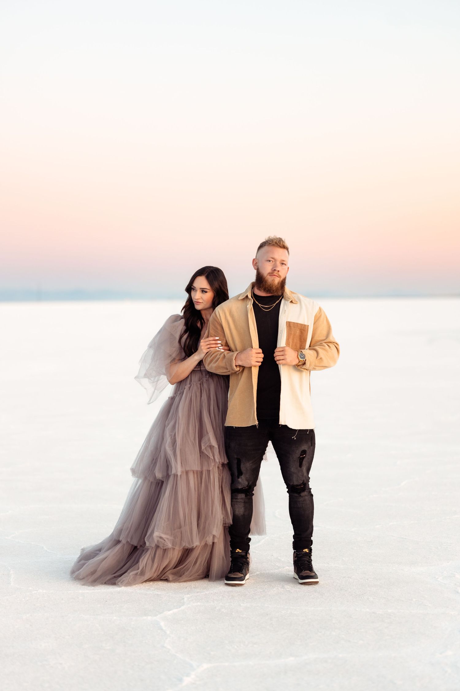 Couple hold each other during Salt Flats photos by Utah couples photographer during sunset