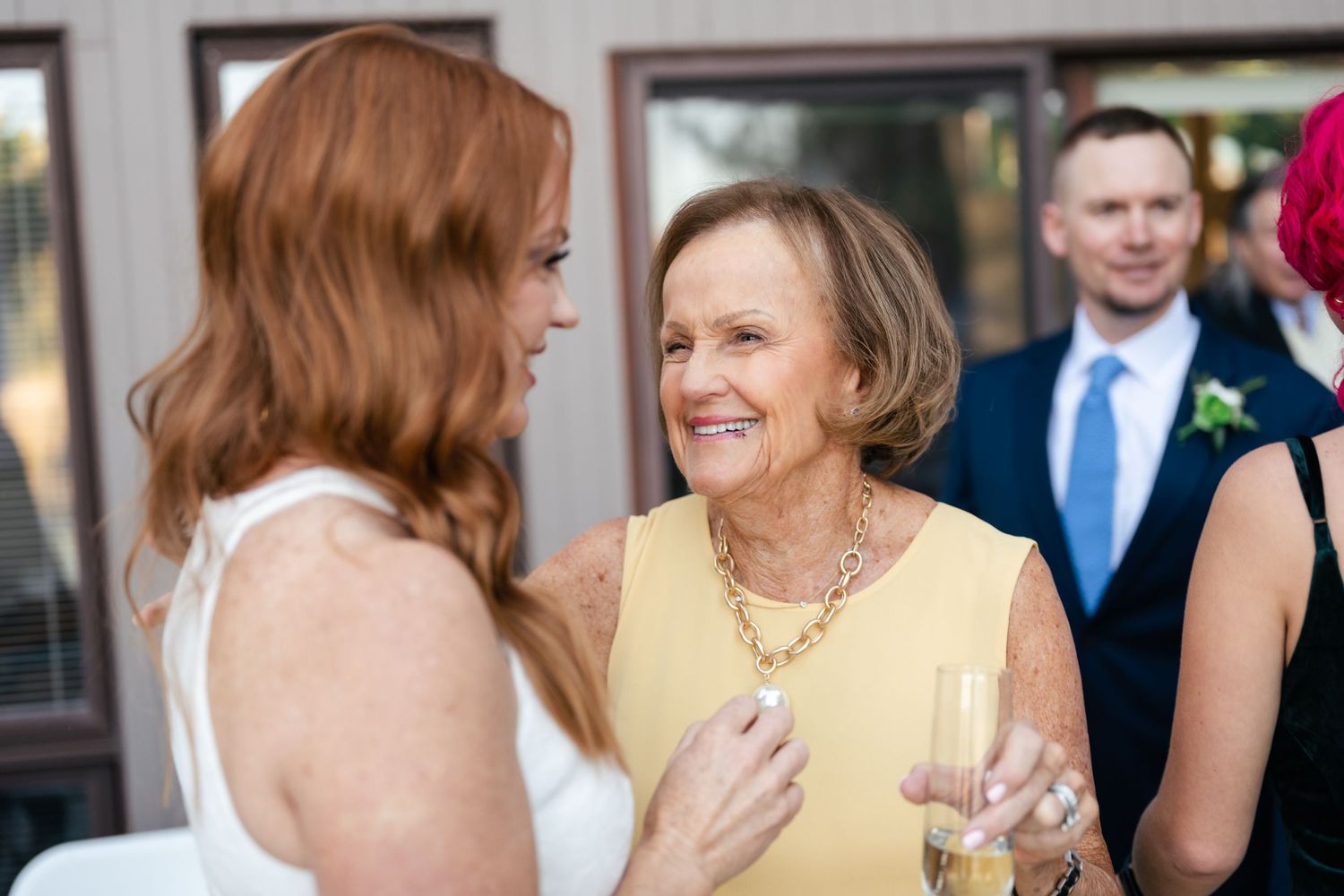 Wedding celebration with guests mingling and socializing in formal attire.