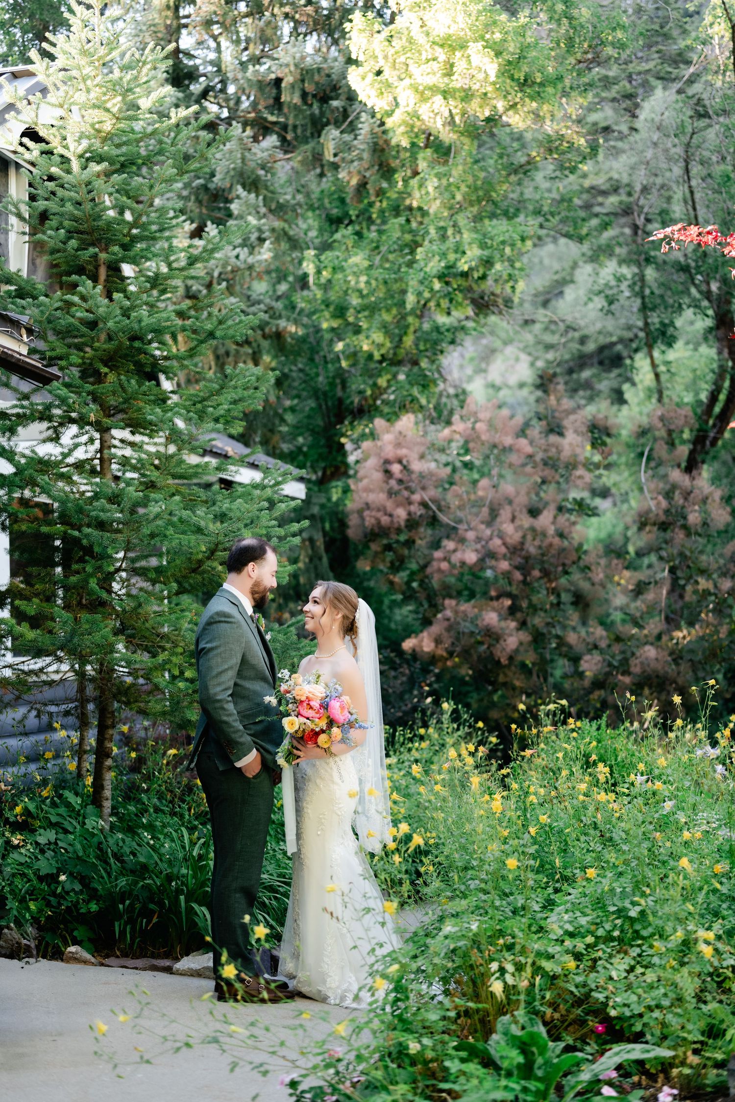 A romantic wedding photo sequence in a garden with yellow wildflowers and lush greenery. Millcreek Inn Wedding Photographer.