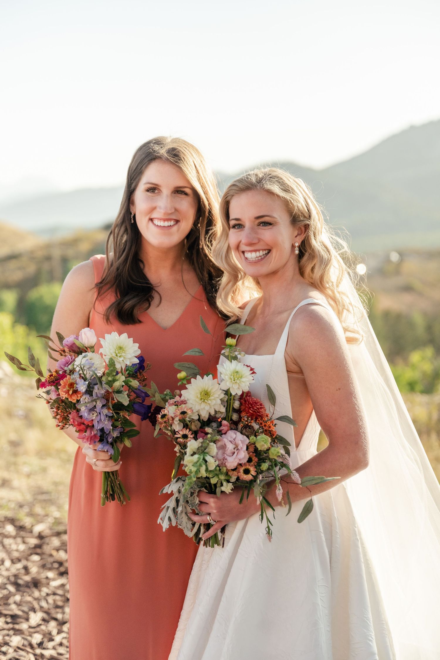 Beautiful wedding bouquets featuring colorful wildflowers against a mountain landscape.