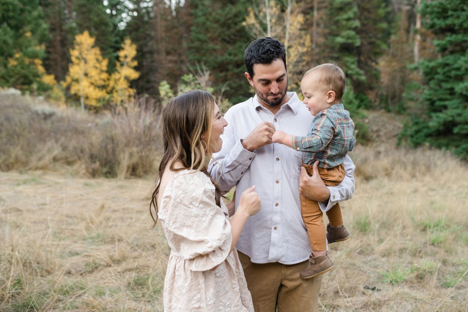 young family has a close cuddle together in American Fork Canyon for their fall family photos