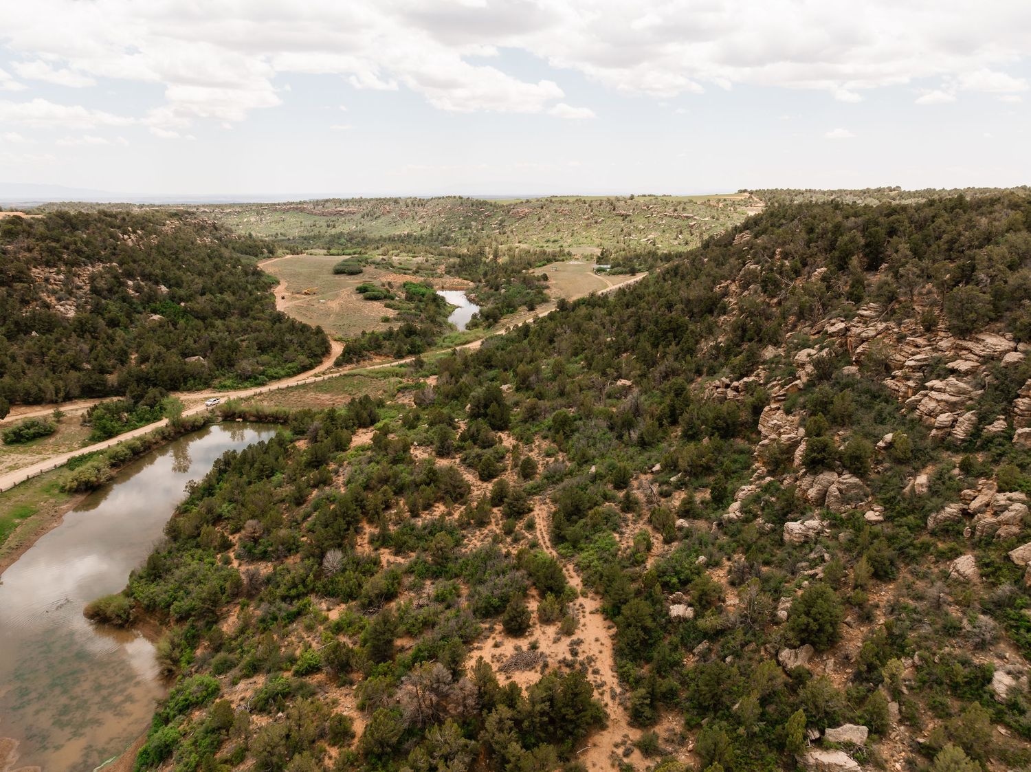 Panoramic view of rolling hills and winding river in a scenic landscape.