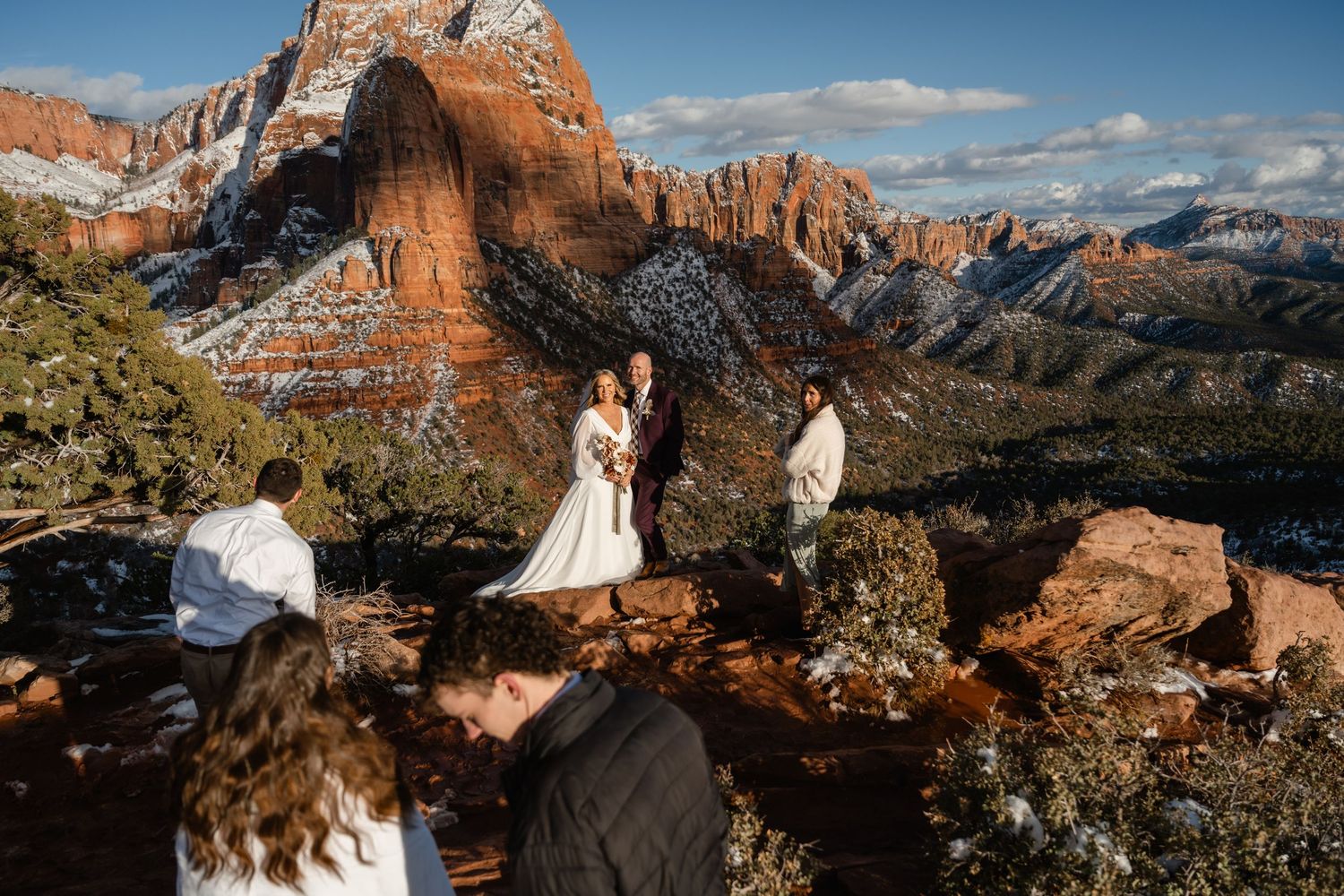 Wedding photography session with dramatic red rock canyon views and blue sky.