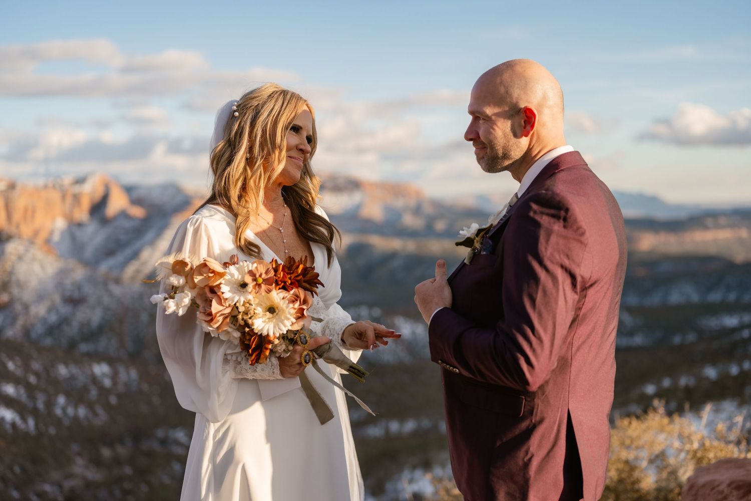 Intimate wedding ceremony at sunset with mountain vistas and dramatic skies.