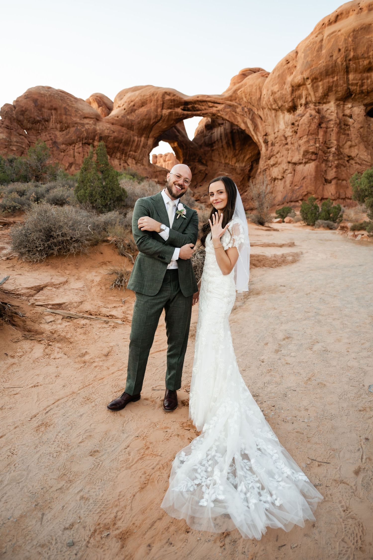 A couple celebrates their wedding day against stunning desert rock formations.