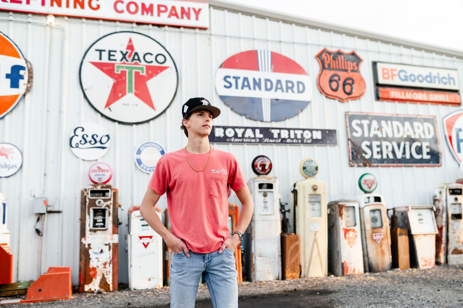 Vintage gas station wall displaying classic Texaco, Standard Oil and Route 66 signs and memorabilia.