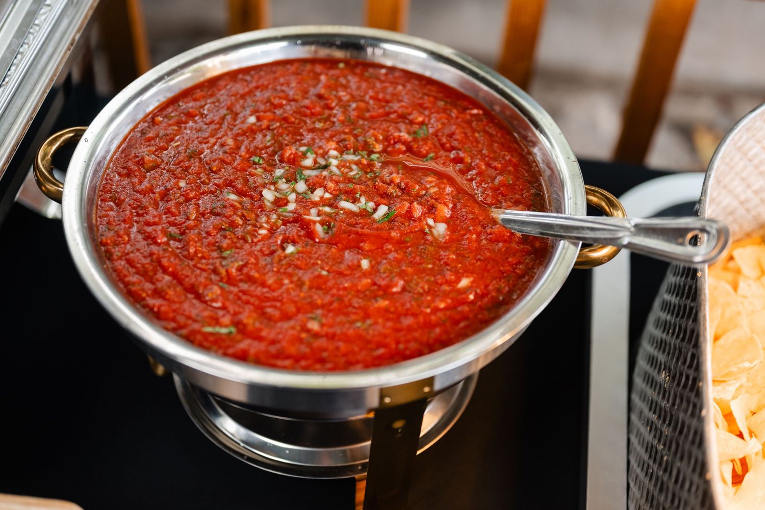 A pot of homemade marinara sauce simmers on the stovetop with visible herbs and seasonings.