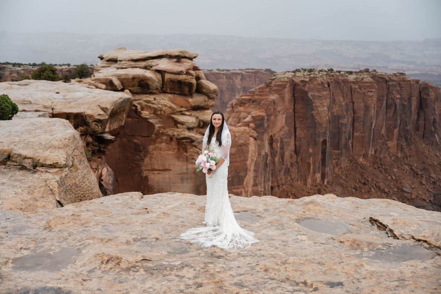 A wedding photography series showing dramatic desert canyon views with red rock cliffs in the background.