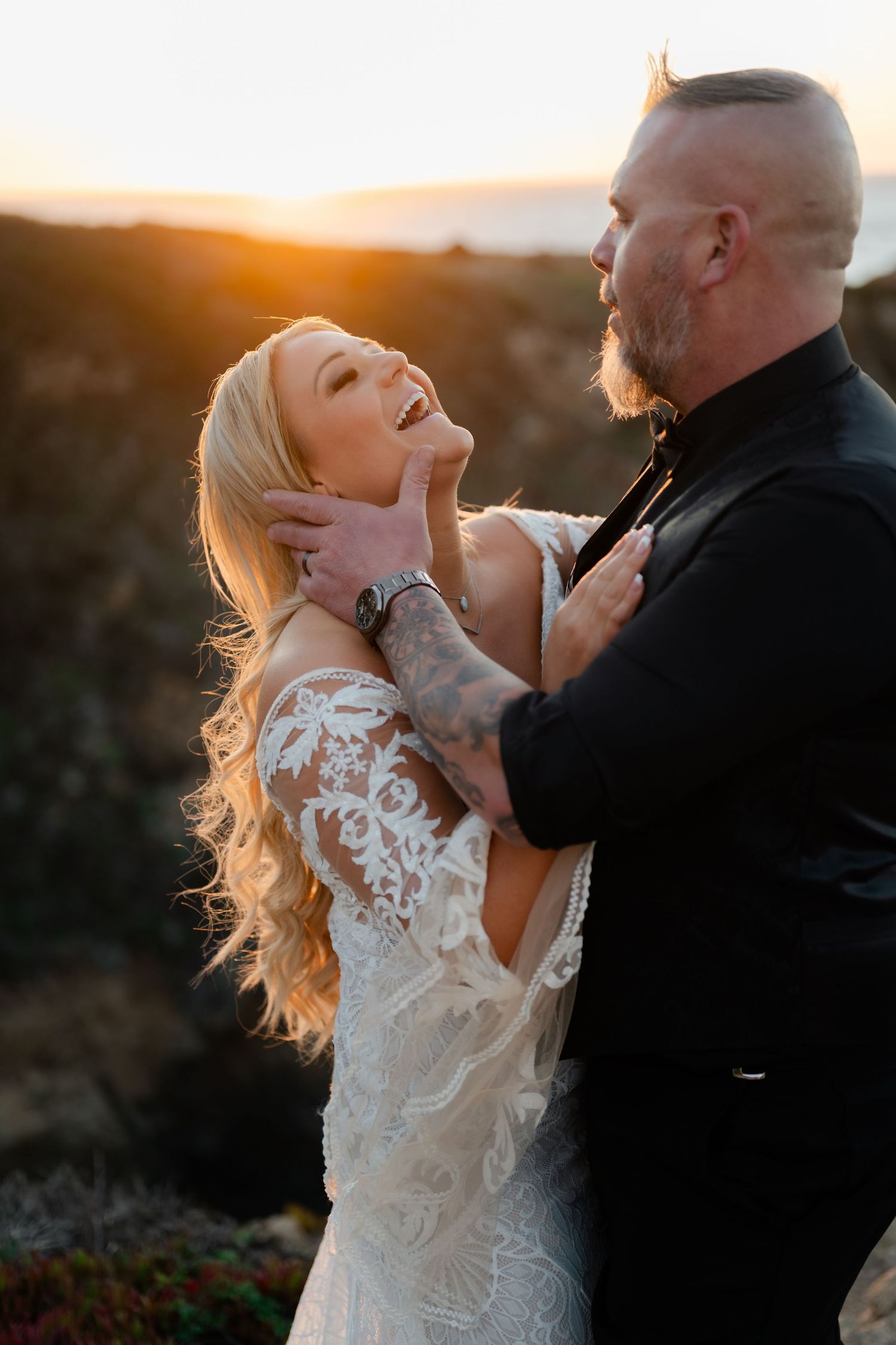 An intimate wedding moment captured during golden hour on a scenic coastal overlook.
