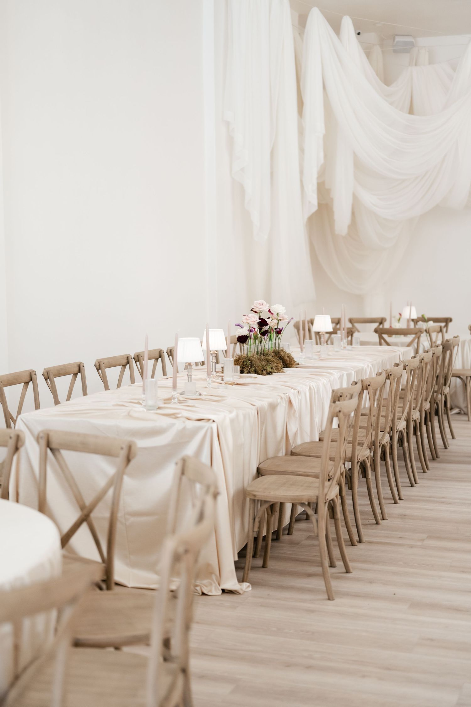 Elegantly draped cake table with florals and ceiling draping at Moments on Main in Payson by Utah Wedding Photographer and Videographer.