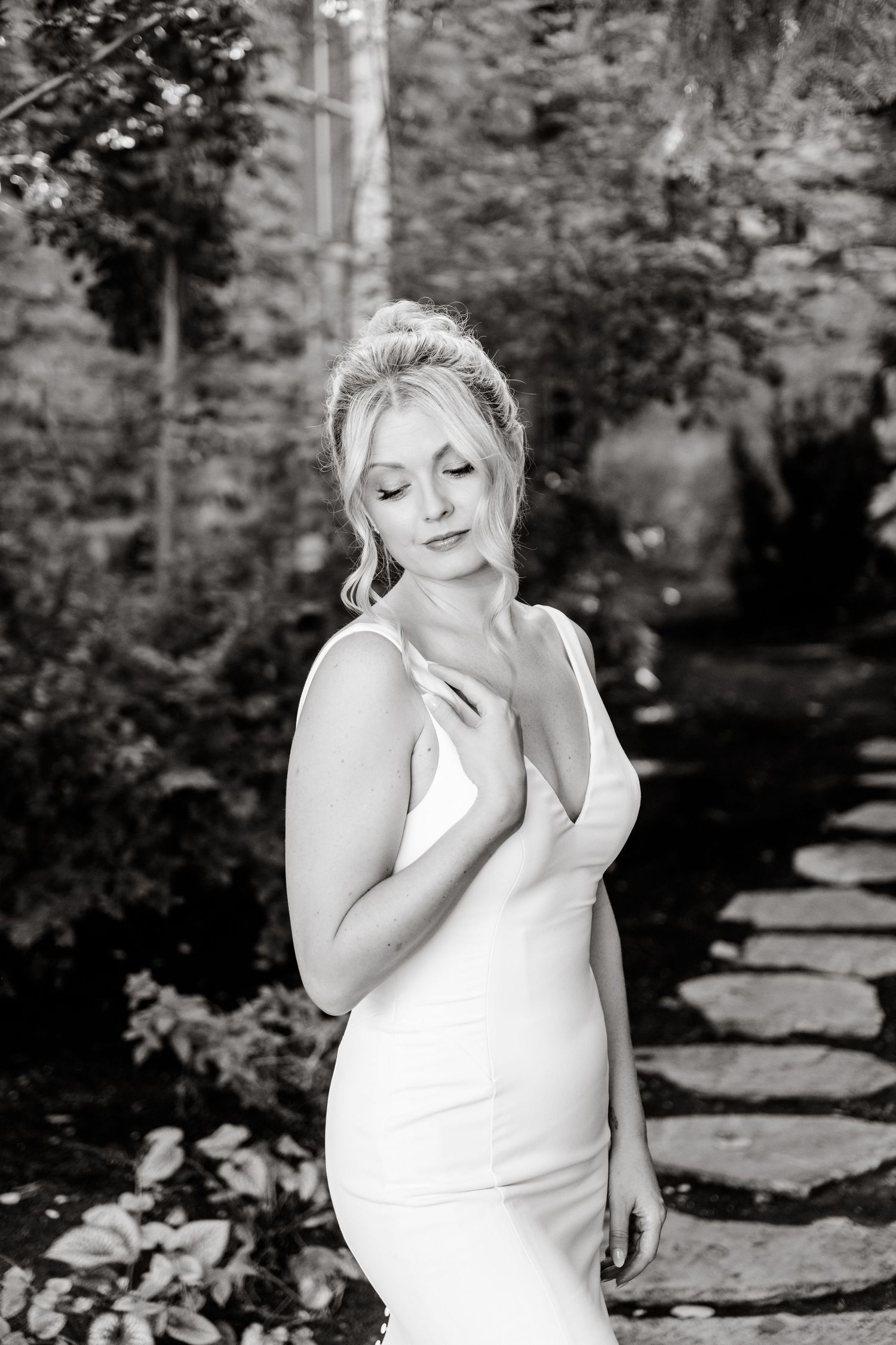 A series of black and white portraits showing emotional expressions and reactions in an outdoor garden setting.