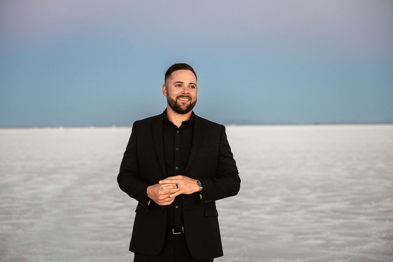 Wedding couple sharing romantic moments at sunset on salt flats.