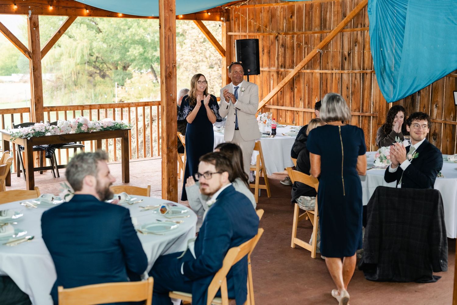 Wedding guests enjoy dancing and socializing at an outdoor reception venue.
