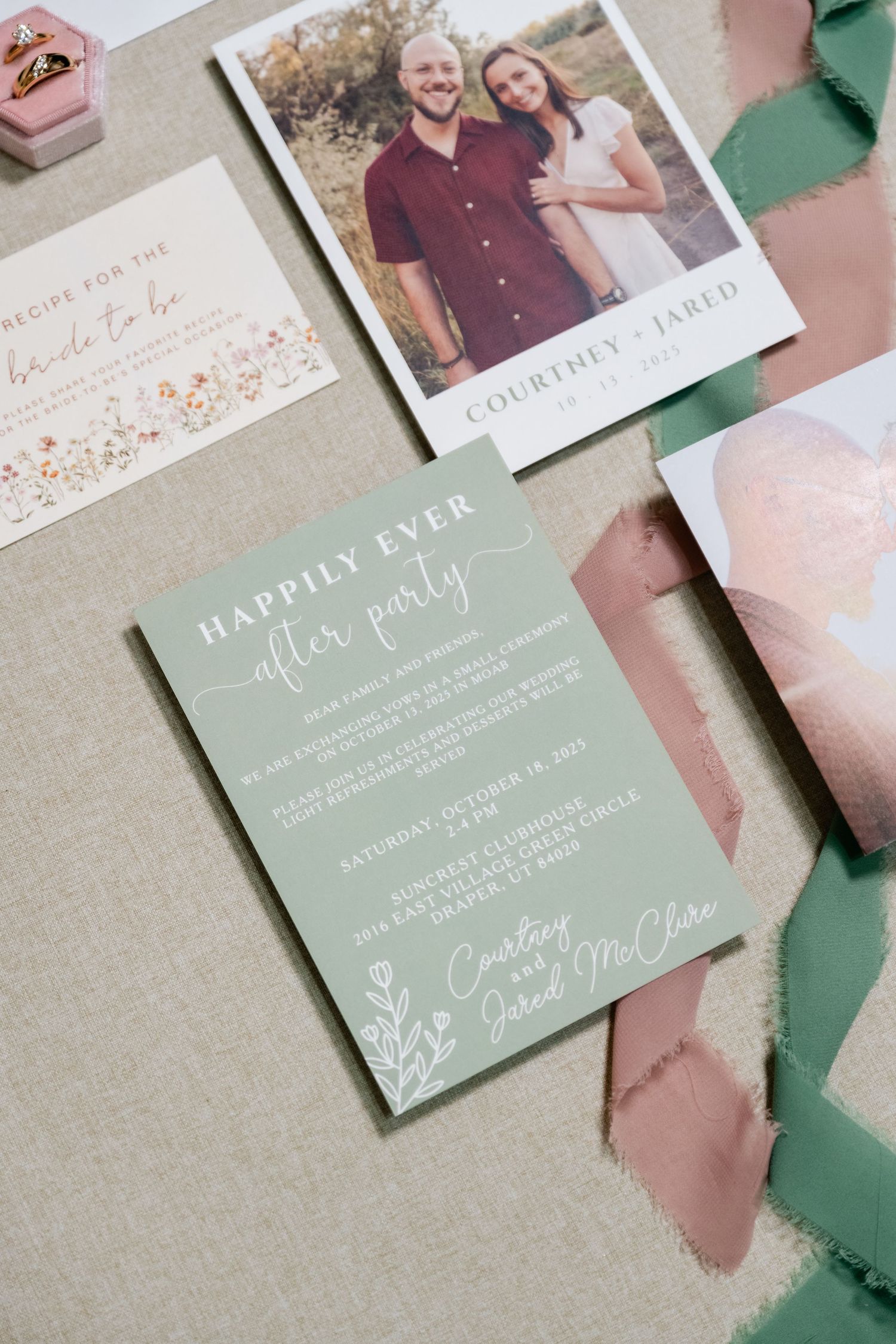 Wedding stationery suite in soft green and pink tones with floral designs.