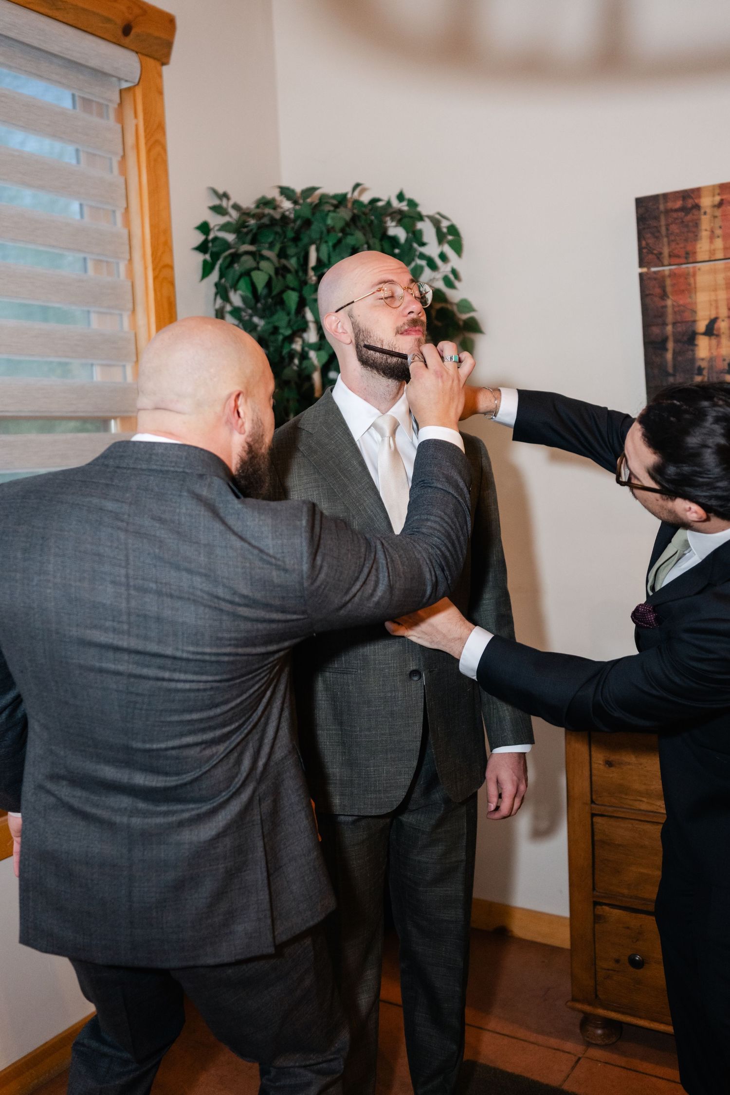 Two men in suits demonstrate self-defense techniques in a series of progressive action shots indoors.