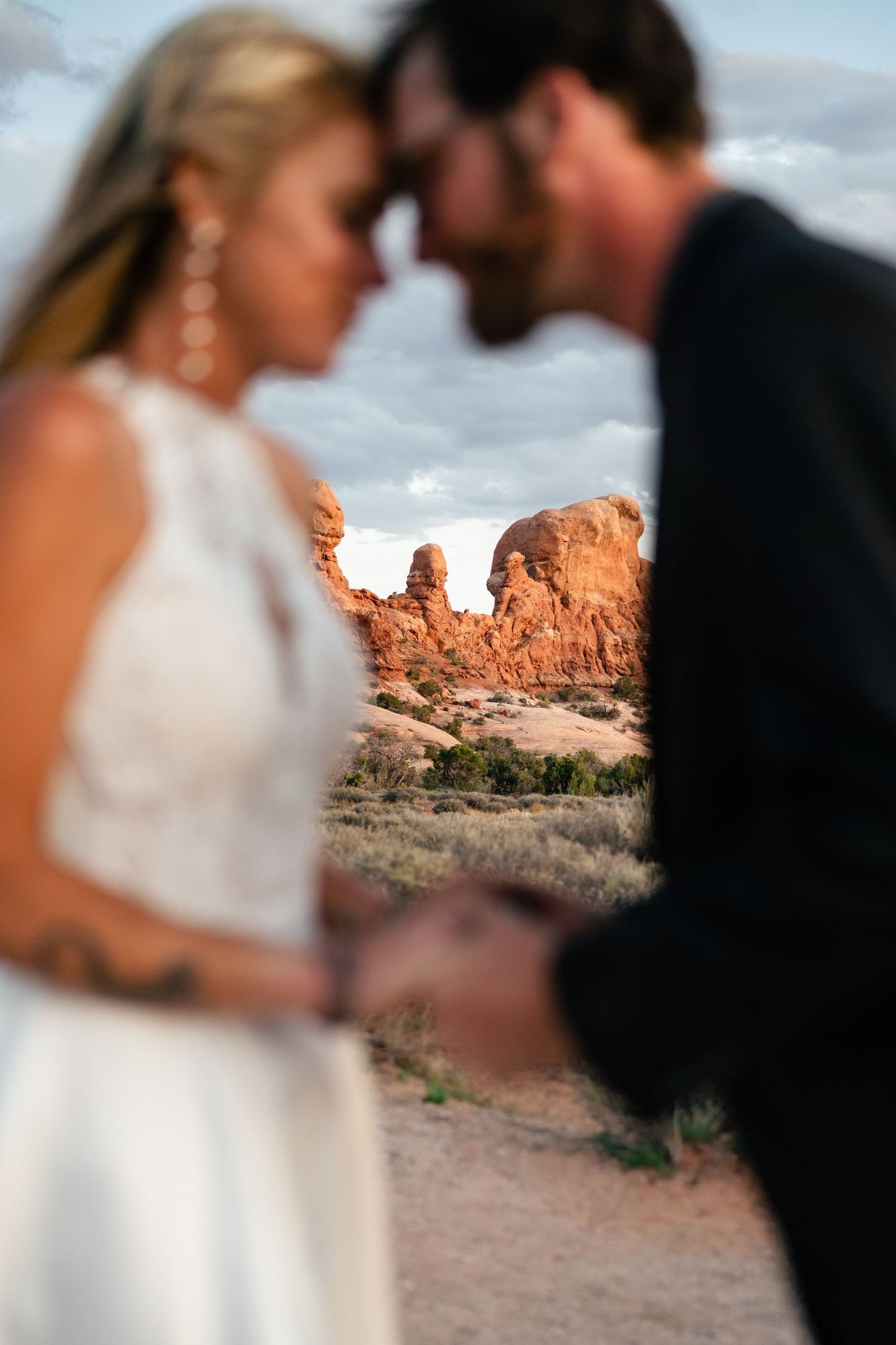 Wedding photo focused on the landscape of Arches NP by Utah Elopement Photographer