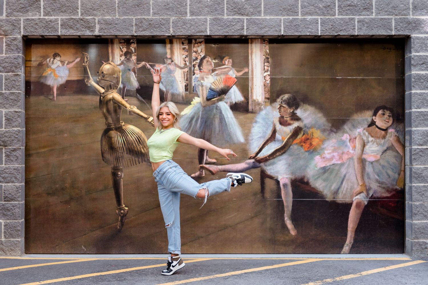 Ballet dancers pose gracefully along a brick wall in a creative urban dance photoshoot series.