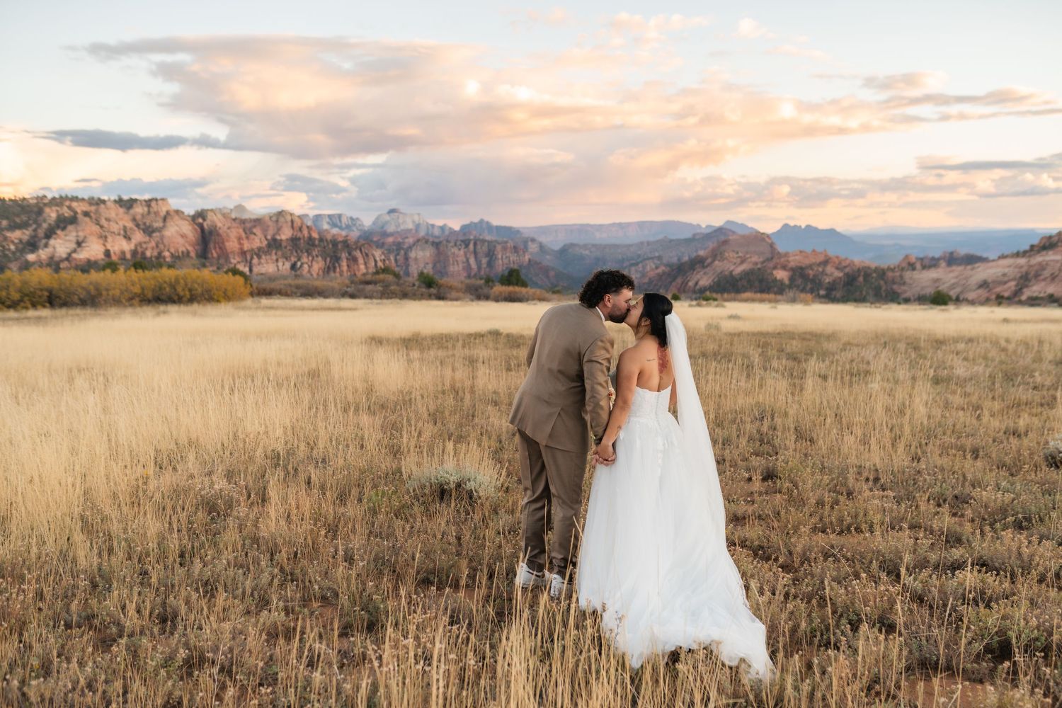 Scenic mountain wedding photography with expansive landscape and golden hour lighting.