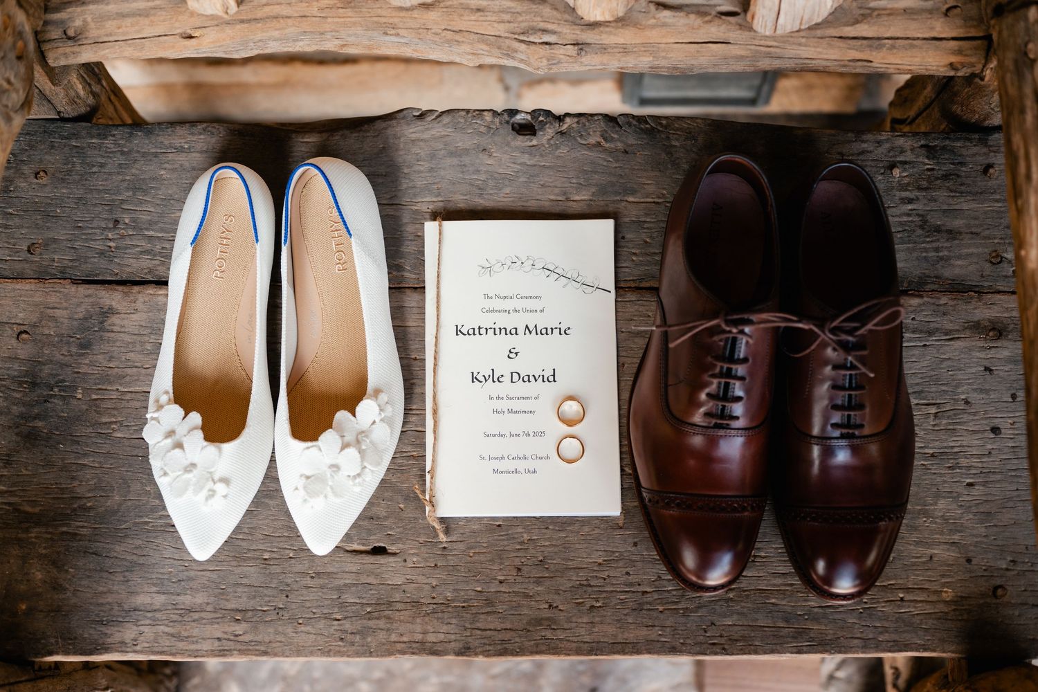 Wedding shoes and accessories arranged artistically on rustic wooden background.