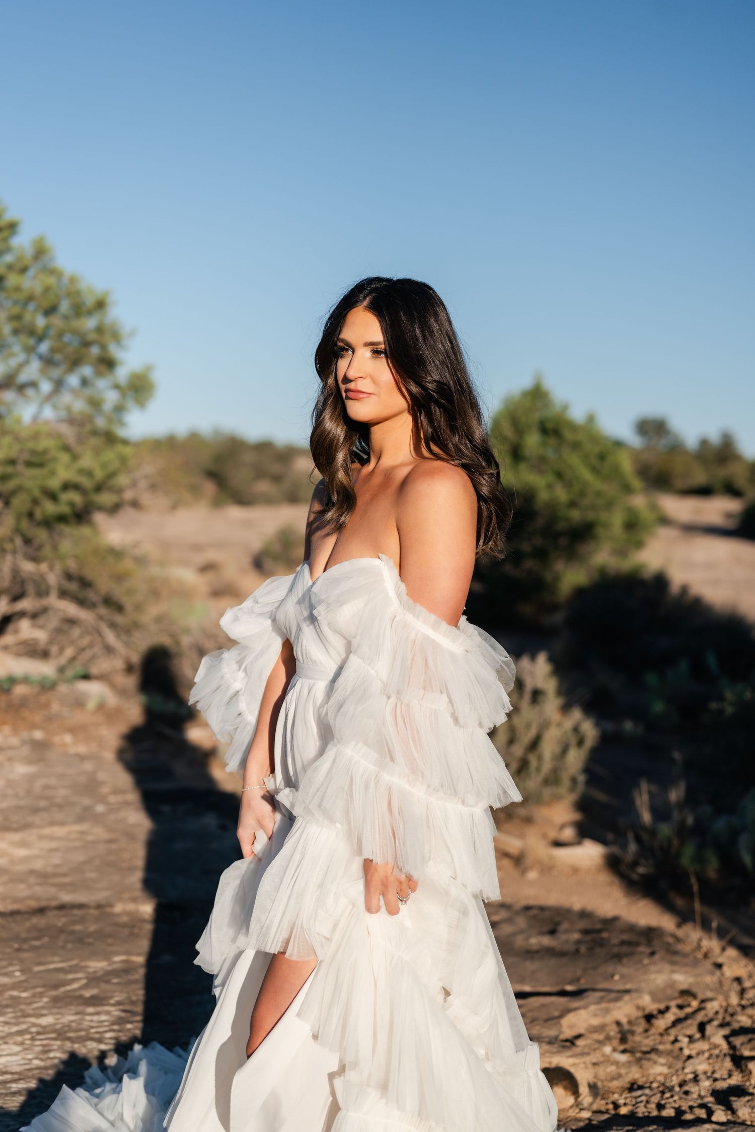 Zion Adventure Session. A flowing white ruffled dress photographed against a desert landscape at sunset.