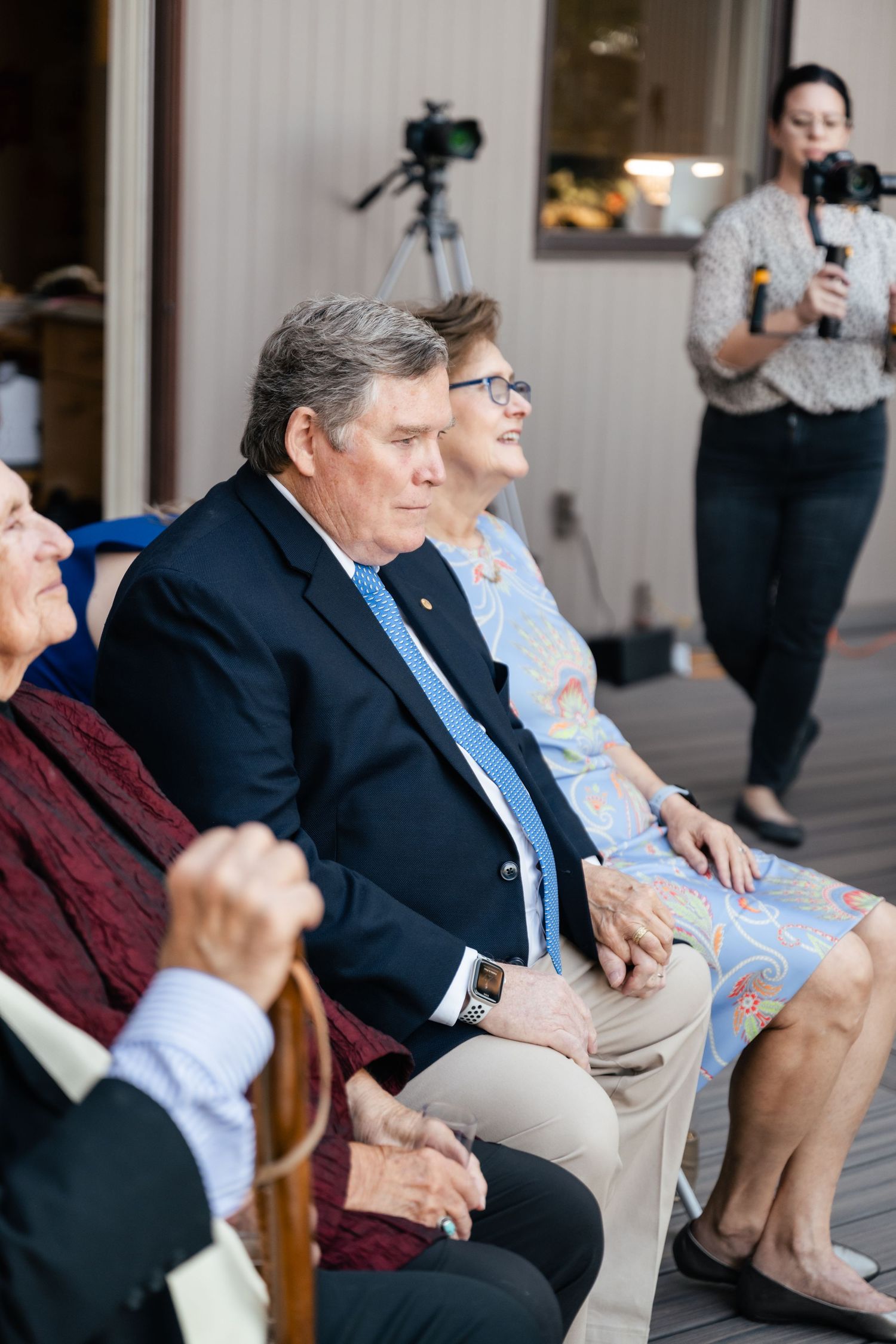 A group of people sitting together on a porch, shown in a series of similar photos taken from different angles.