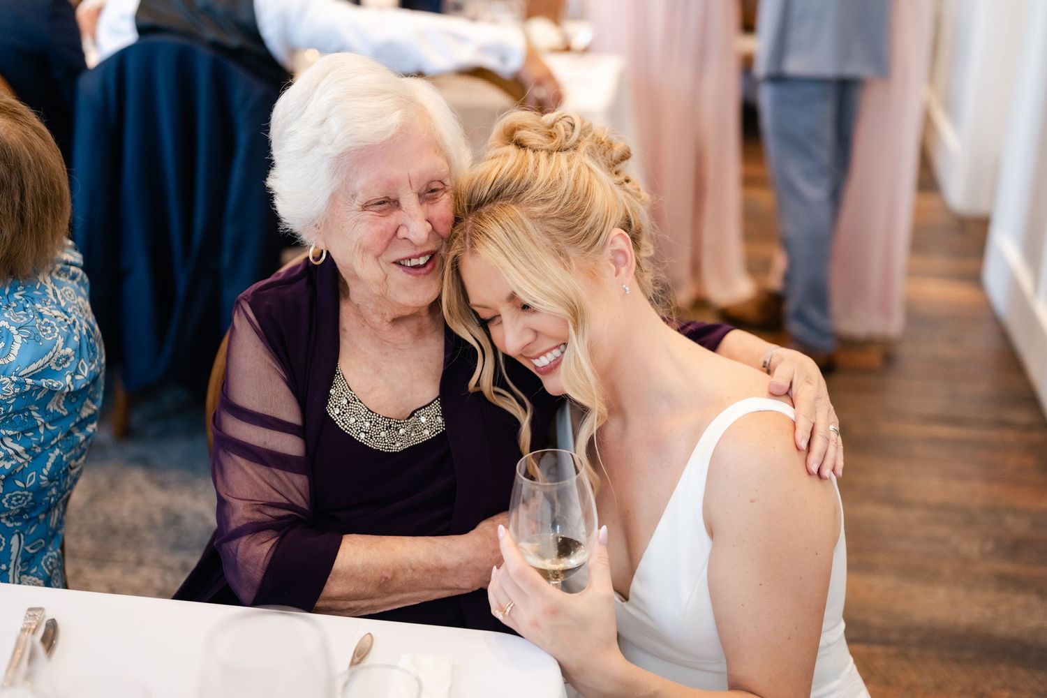 Wedding guests sharing emotional moments during reception celebration.