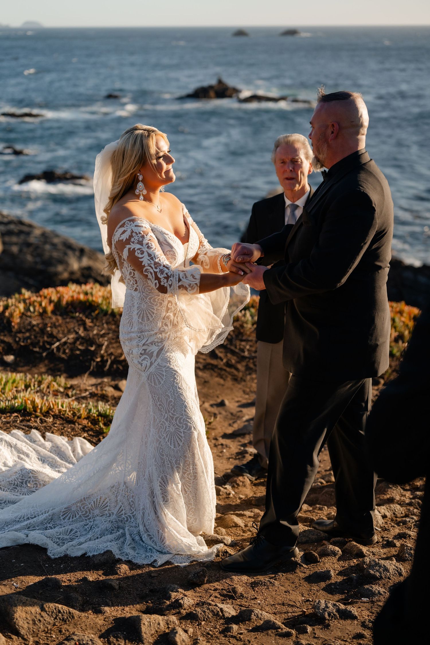 A couple shares intimate moments during their coastal wedding photoshoot at golden hour.