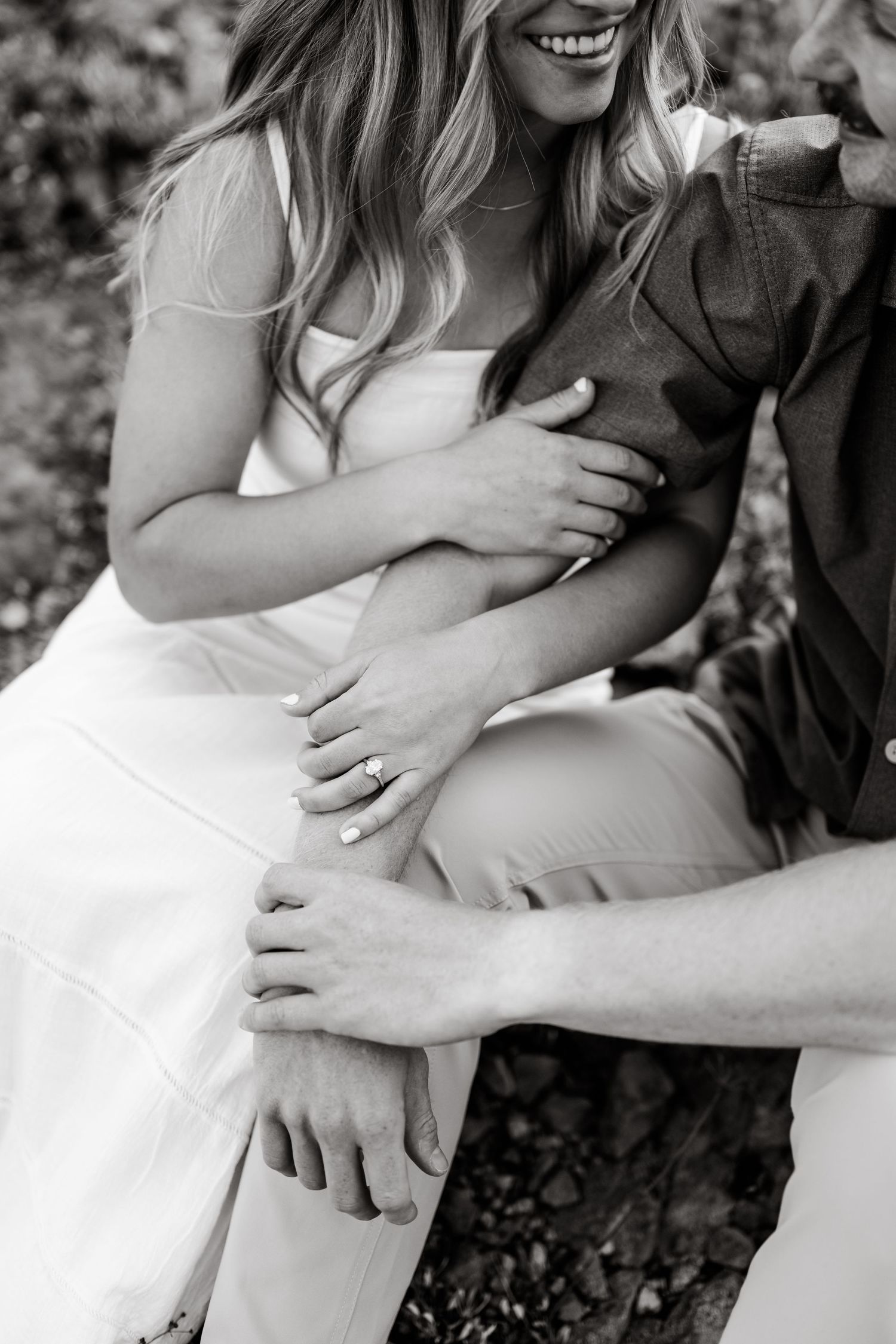 Detailed black and white photo of couple holding arm in arm during their Park City surprise proposal by Park City proposal photographer.
