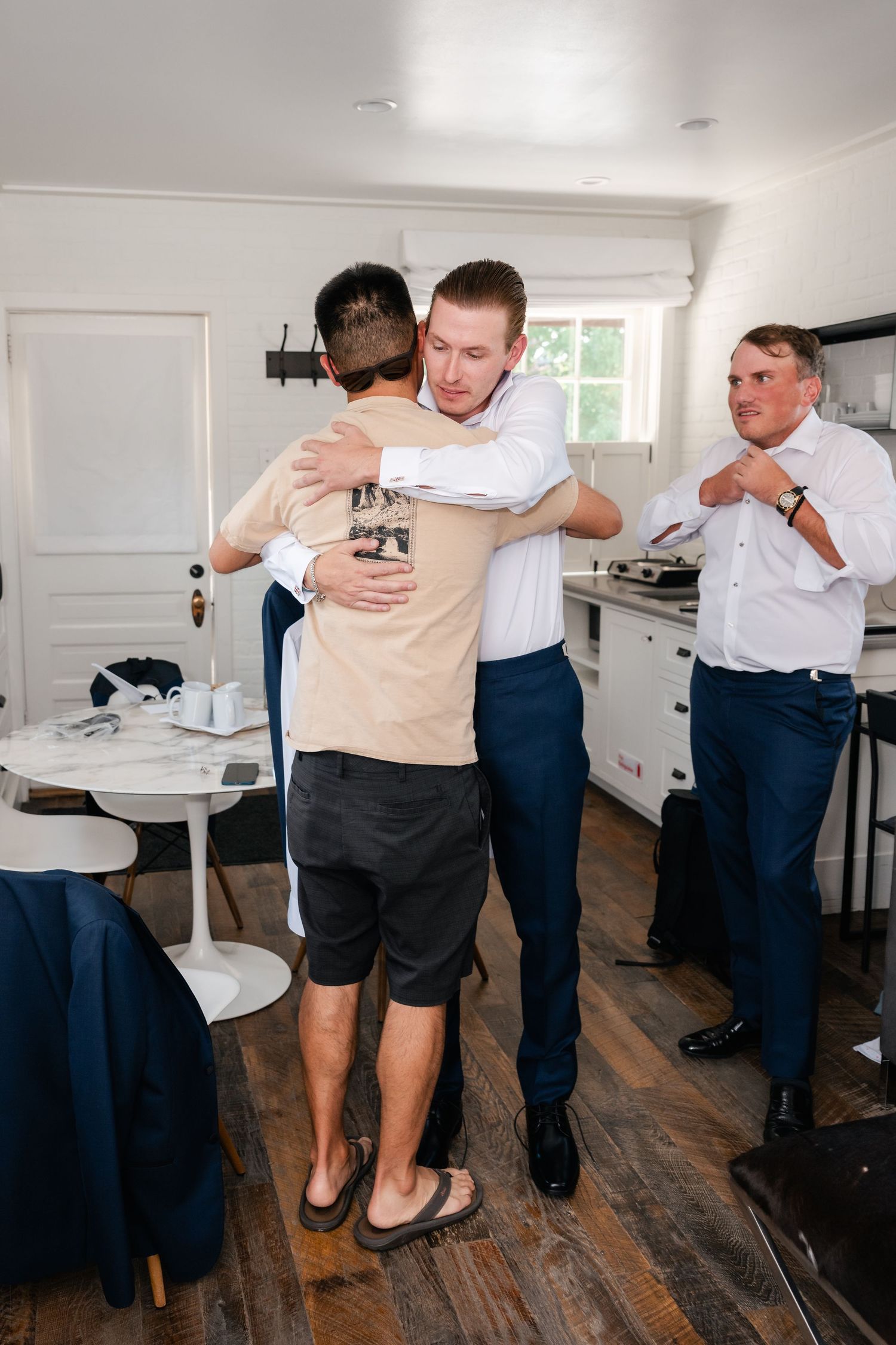 Sequence of men helping each other get dressed in formal attire.