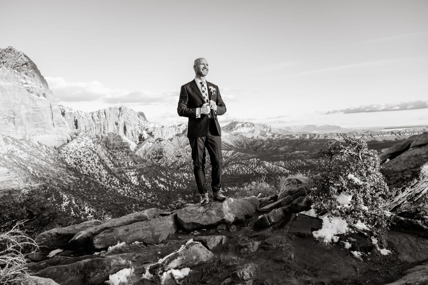 Black and white panoramic view of rugged desert mountain landscapes and rock formations.