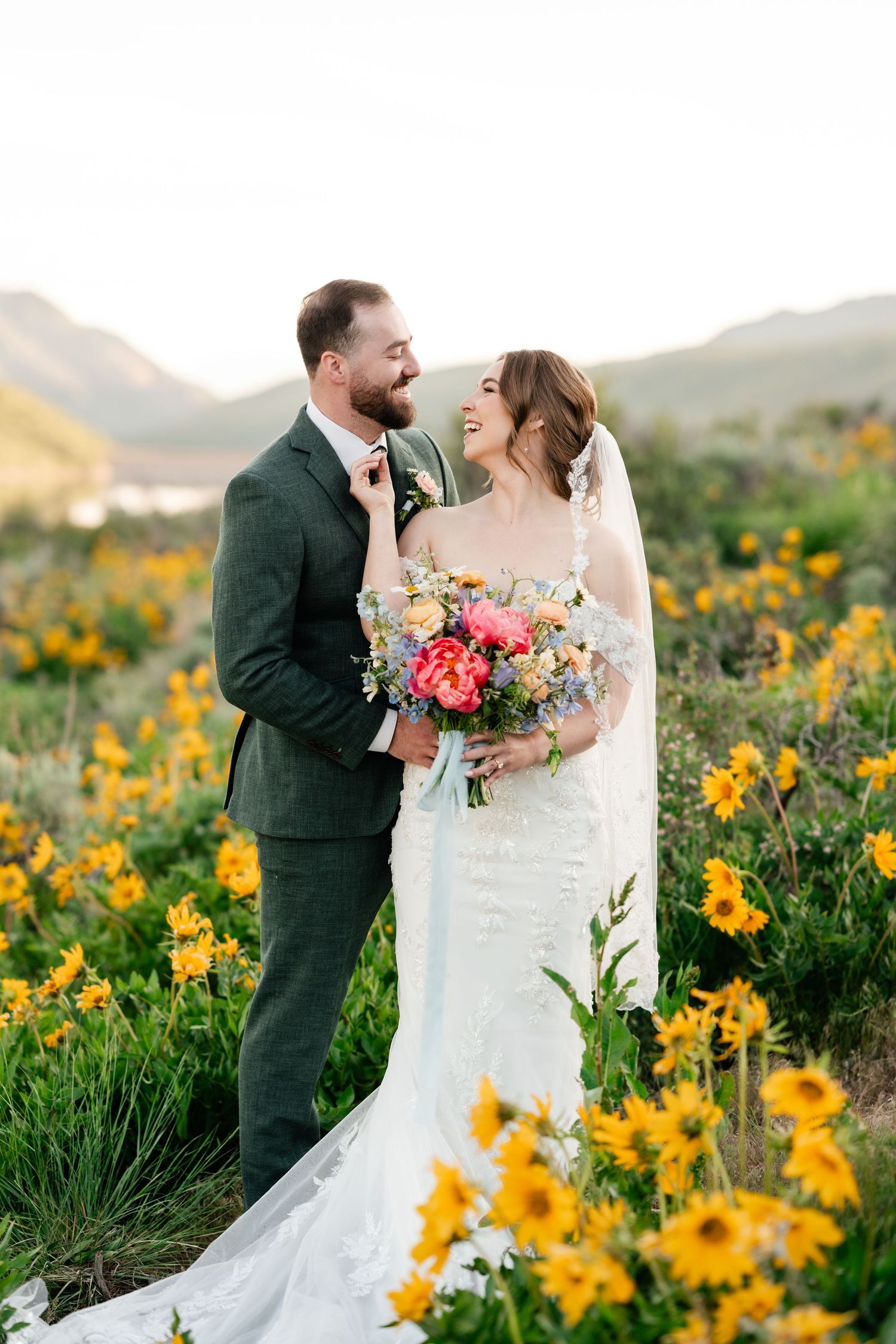 Romantic wedding portraits in a field of vibrant yellow wildflowers at sunset.