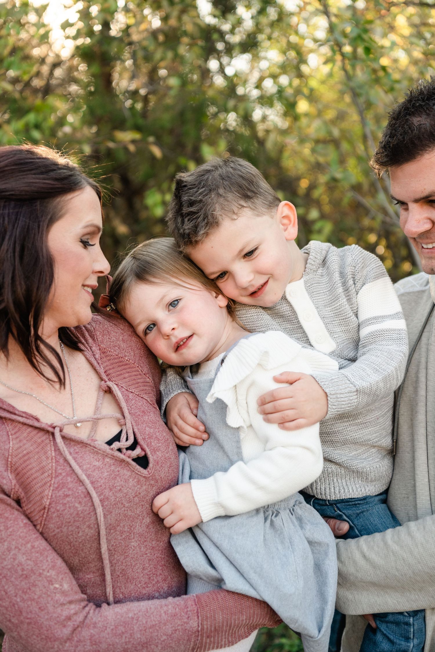 A tender family moment captured in a series of candid photos showing loving embraces and playful interactions outdoors.