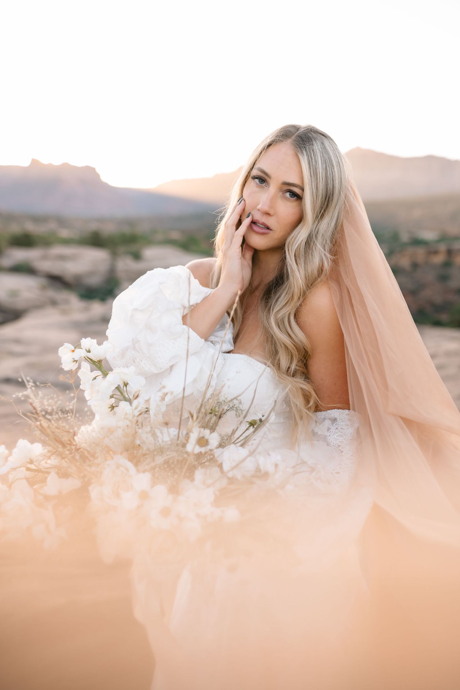 Zions wedding photographer takes beautiful desert sunrise bridals featuring a unique veil and dried floral bouquet.