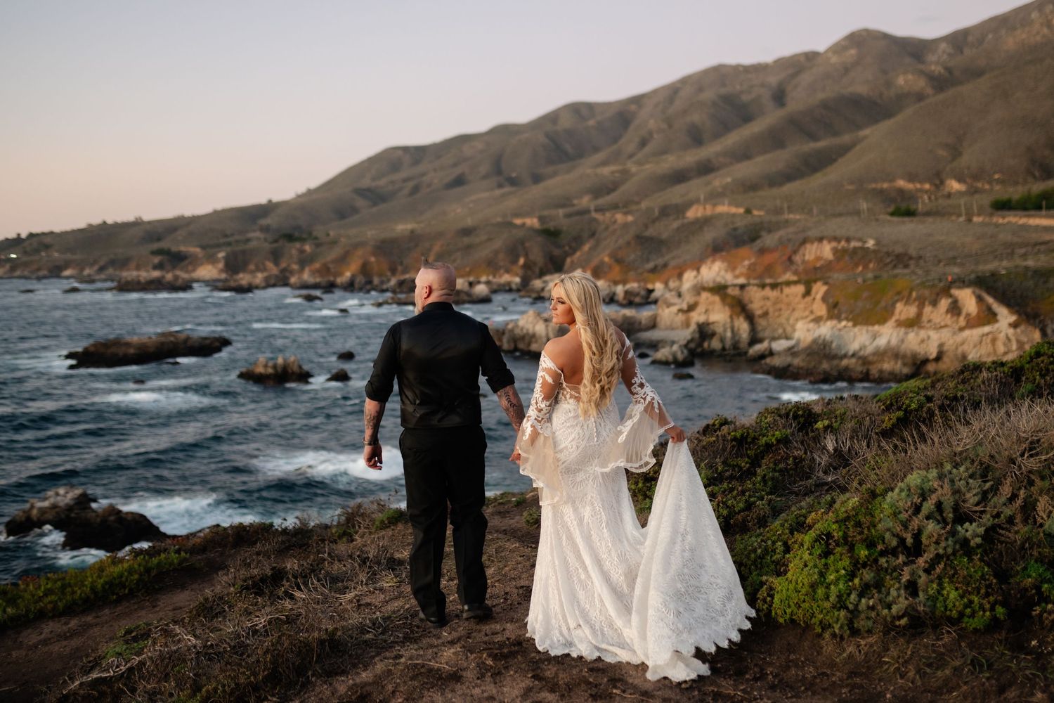 Dramatic coastal landscape with mountains and ocean views at golden hour.