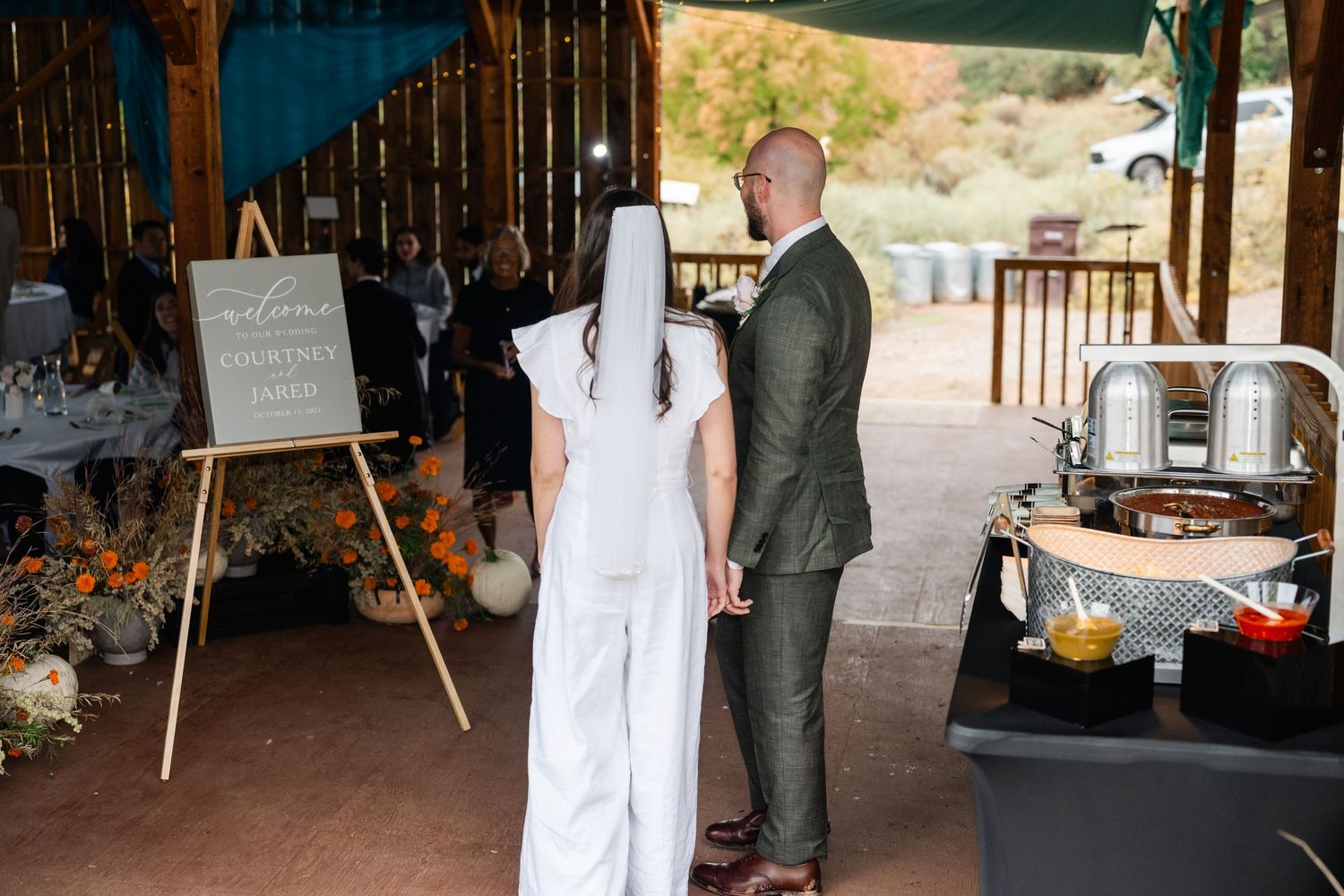 Catering staff preparing food service at an outdoor wedding venue.