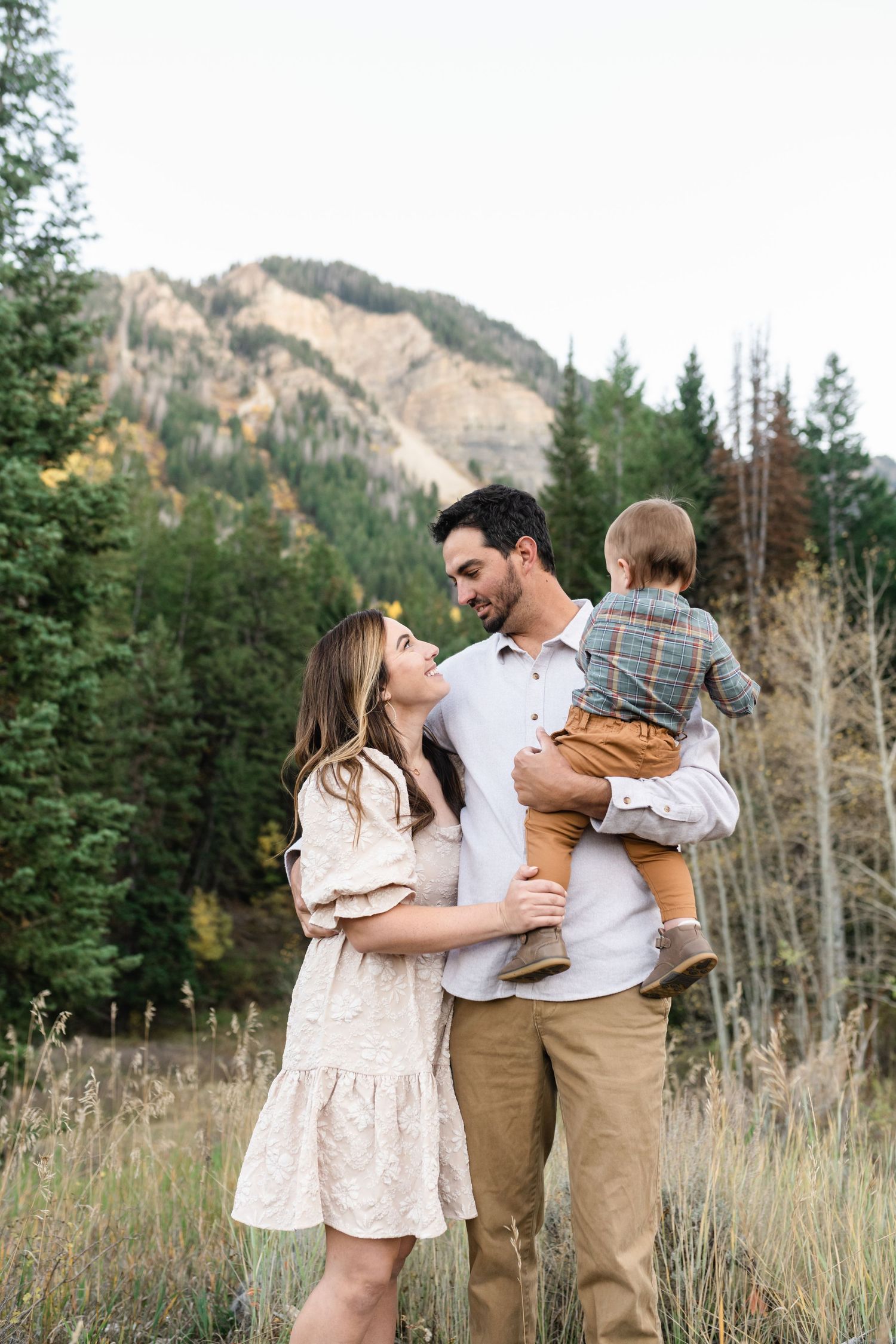 young family has a close cuddle together in American Fork Canyon for their fall family photos
