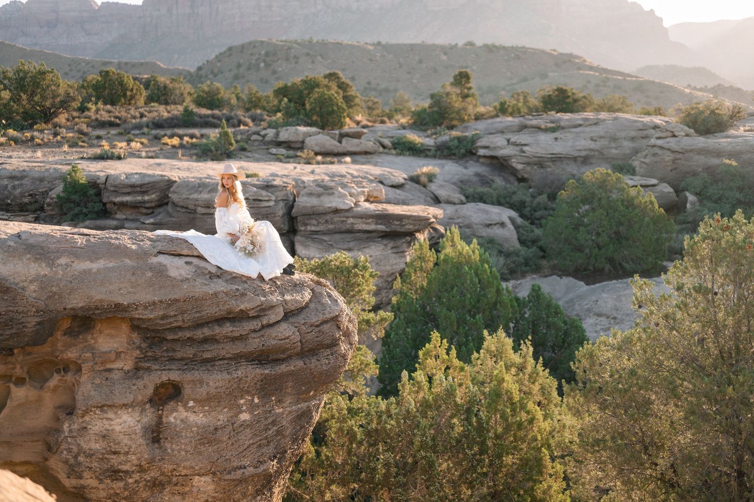 Zions wedding photographer takes beautiful desert sunrise bridals featuring a unique veil and dried floral bouquet.