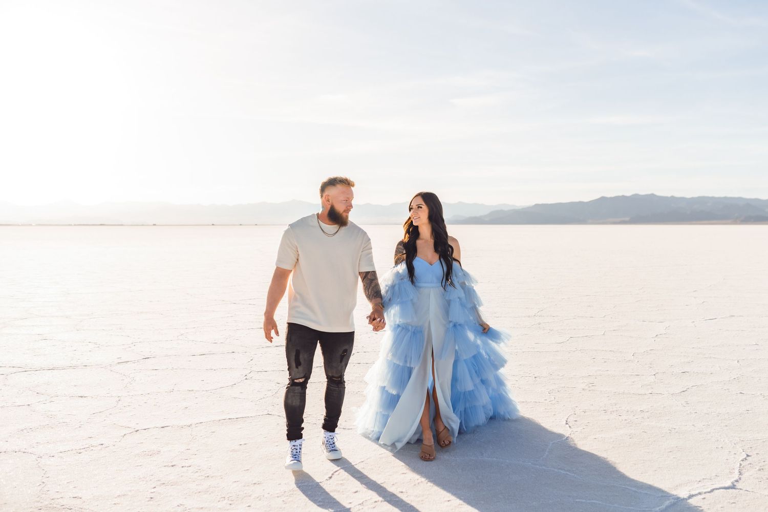 Couple holds hands during golden hour at the Salt Flats by Utah Salt Flats photographer