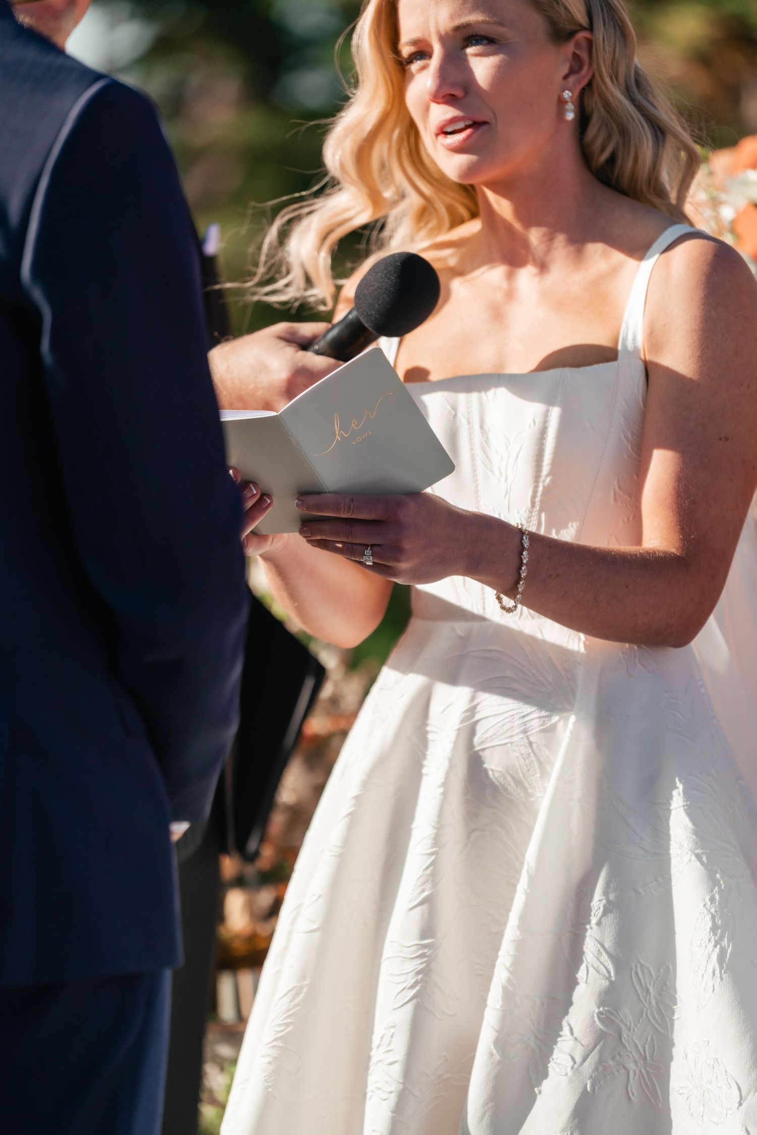 Wedding ceremony moment captured in bright natural sunlight.