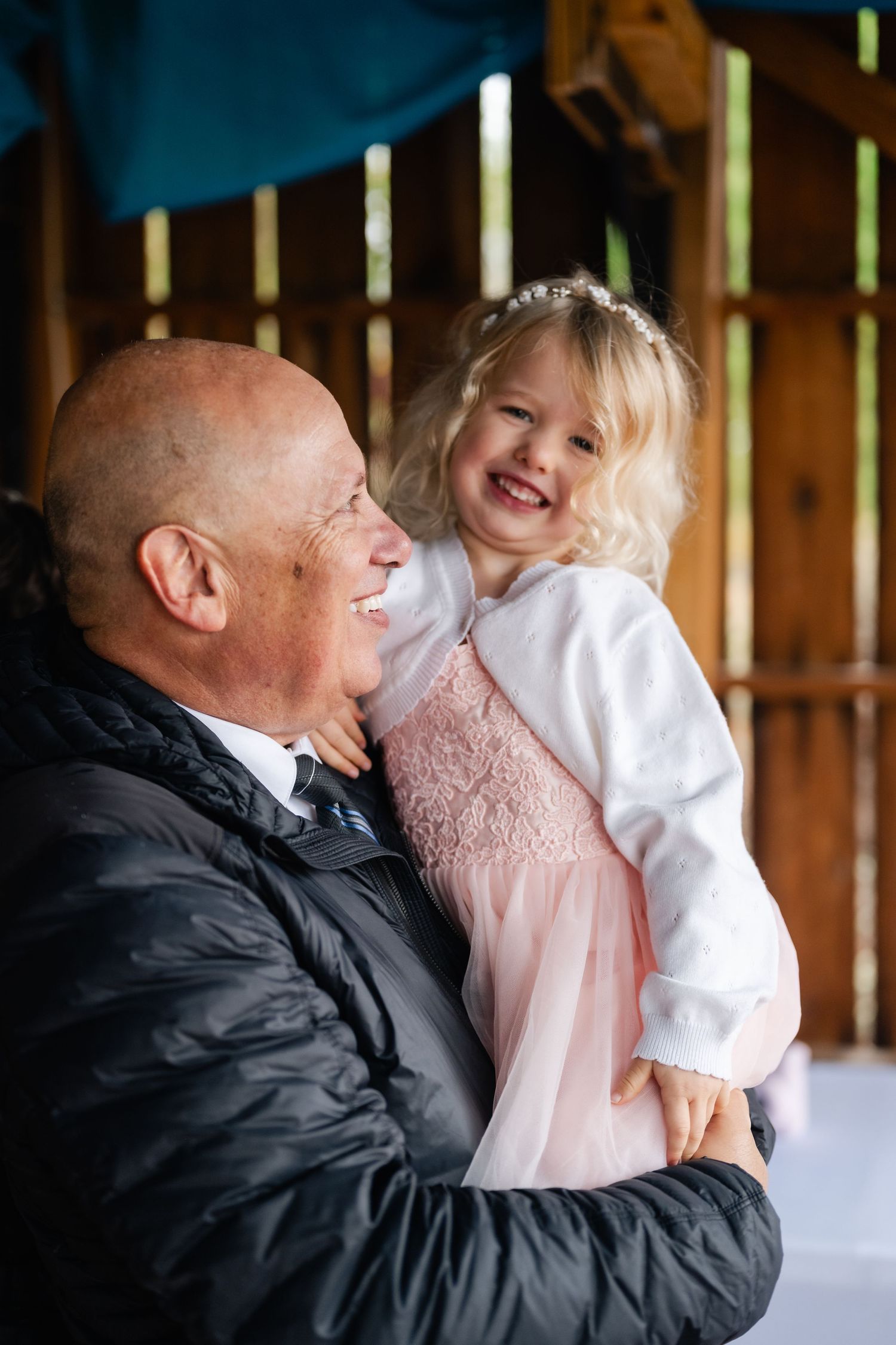 A touching moment shared between two people in a rustic barn setting.