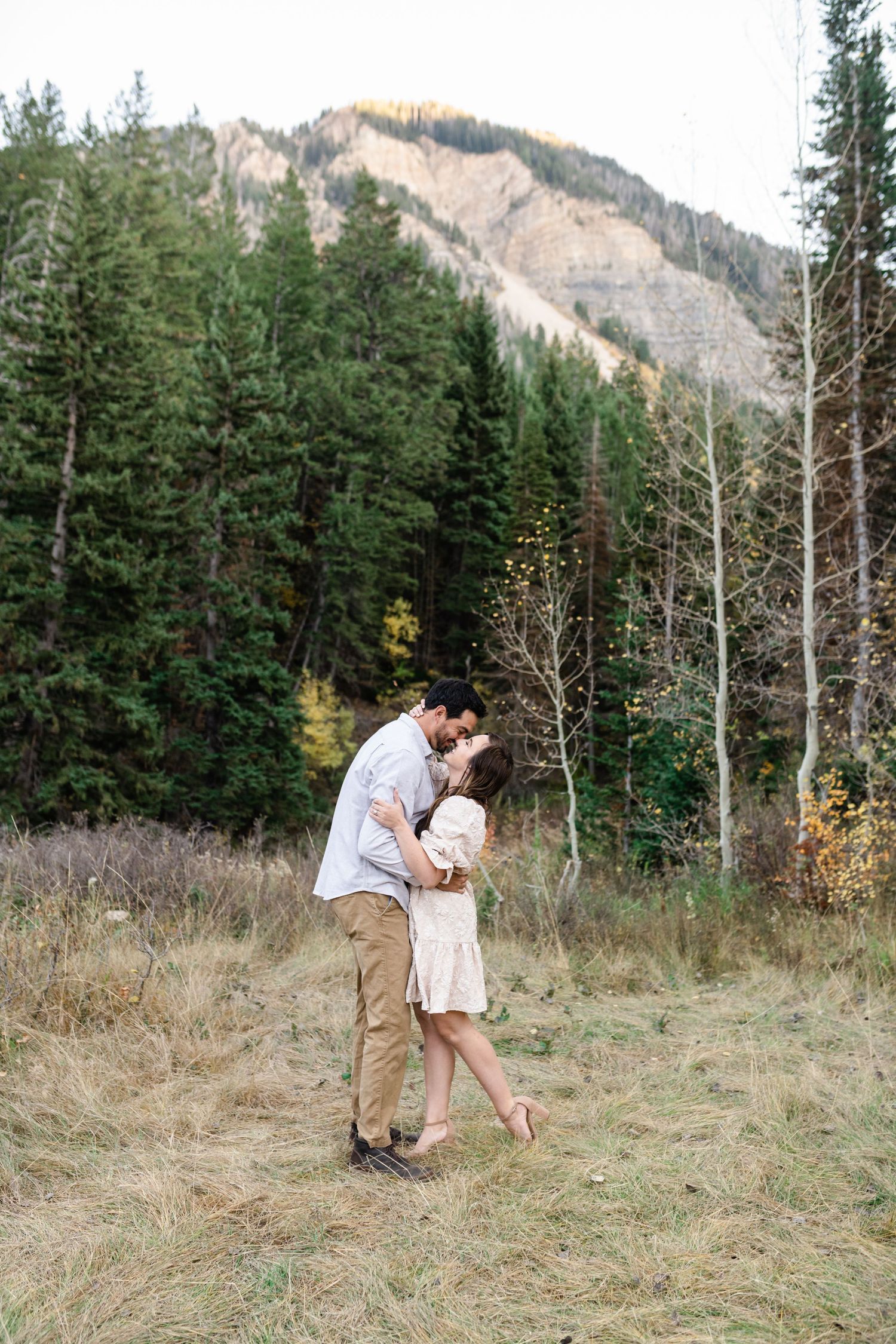 Husband and wife get portraits together young family has a close cuddle together during their fall family photos