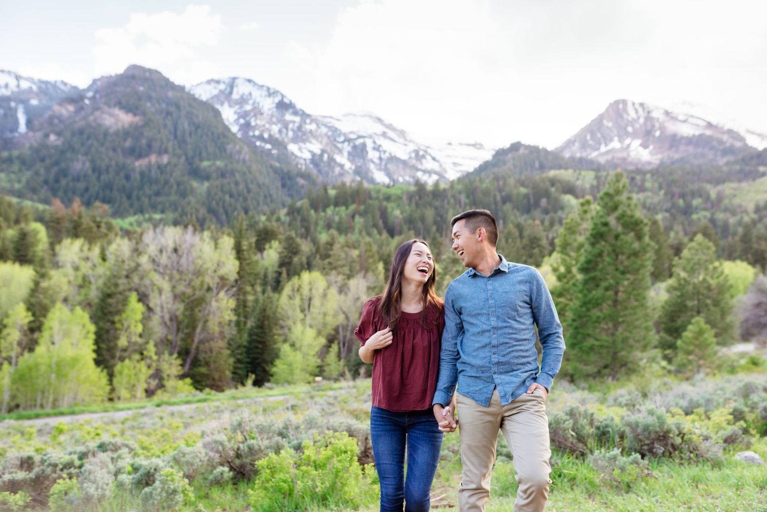 A couple enjoying a scenic mountain view together during springtime.