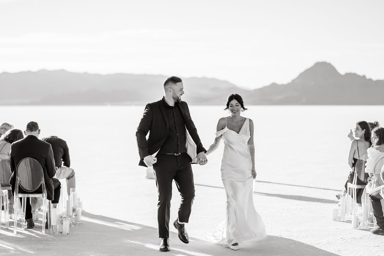 Black and white panoramic shot of wedding ceremony on salt flats.