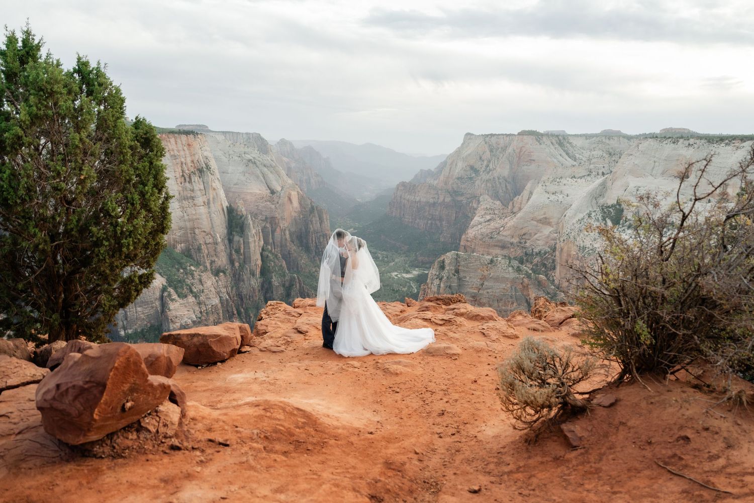 A stunning panoramic series of photos showing a couple at Zion National Park's red rock cliffs during sunset. Utah Elopement Photographer.