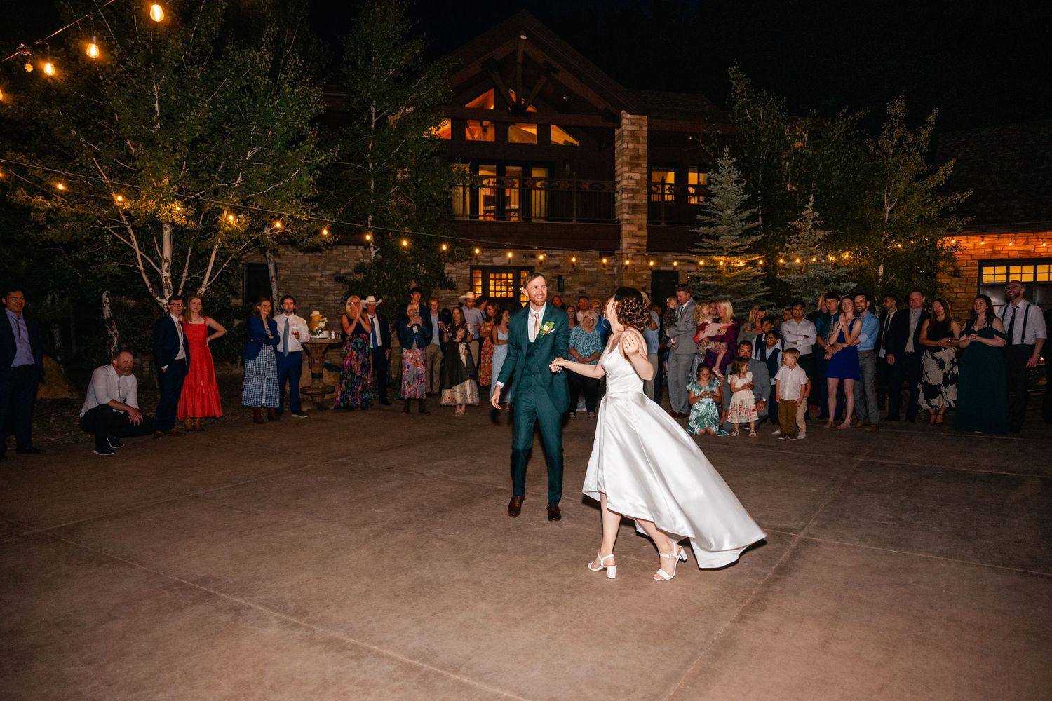 Wedding reception dance floor at night with string lights creating a romantic atmosphere.