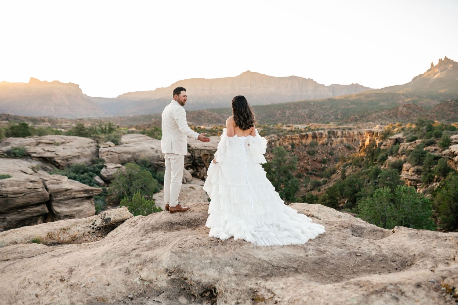 Zion Adventure Session. Scenic desert landscape wedding photos taken at sunset with mountain views and red rock formations.