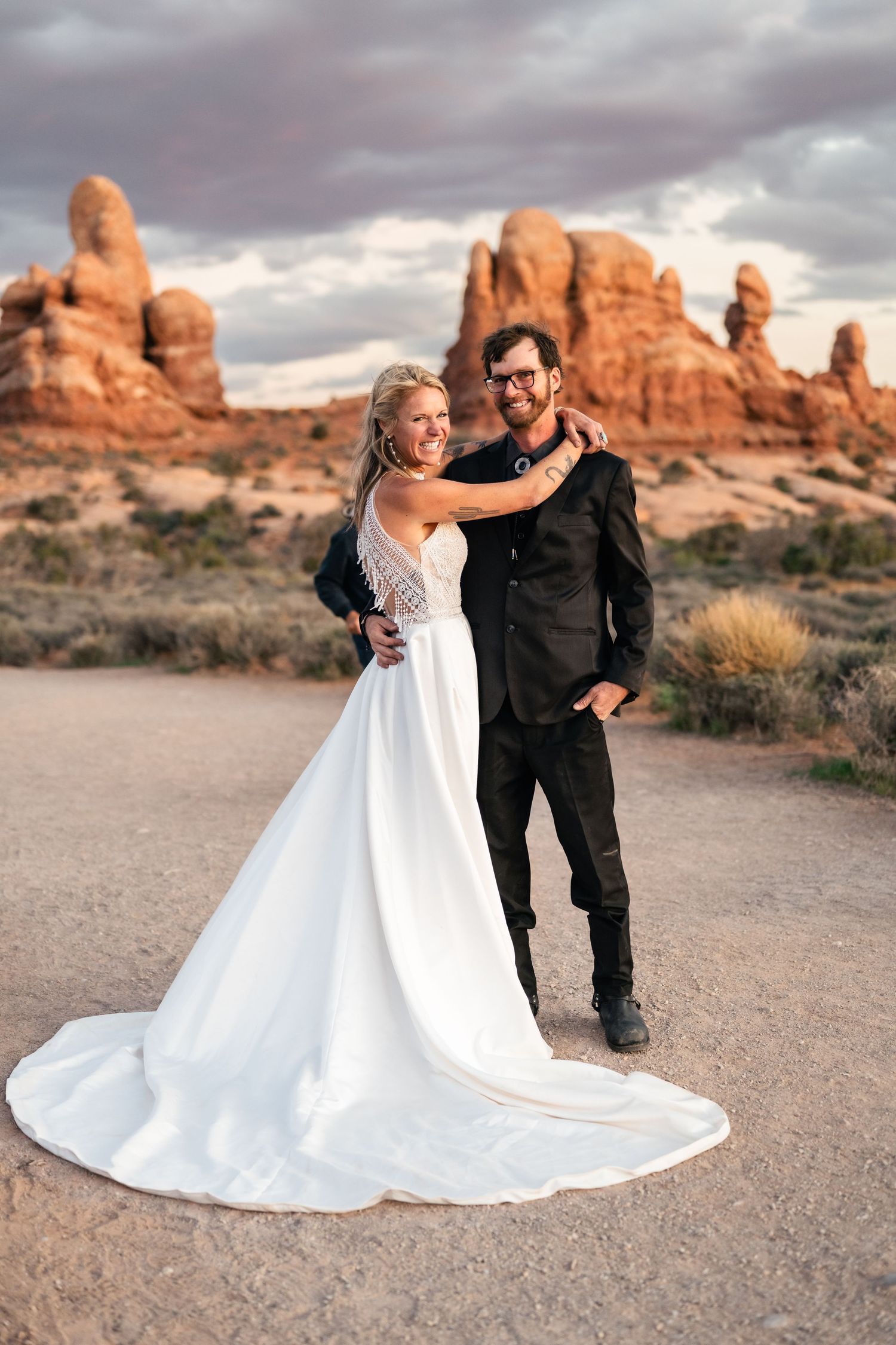 Elopement couple laughs during their wedding photos session in Arches National Park