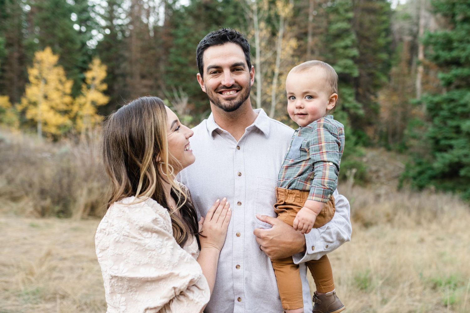 young family has a close cuddle together in American Fork Canyon for their fall family photos