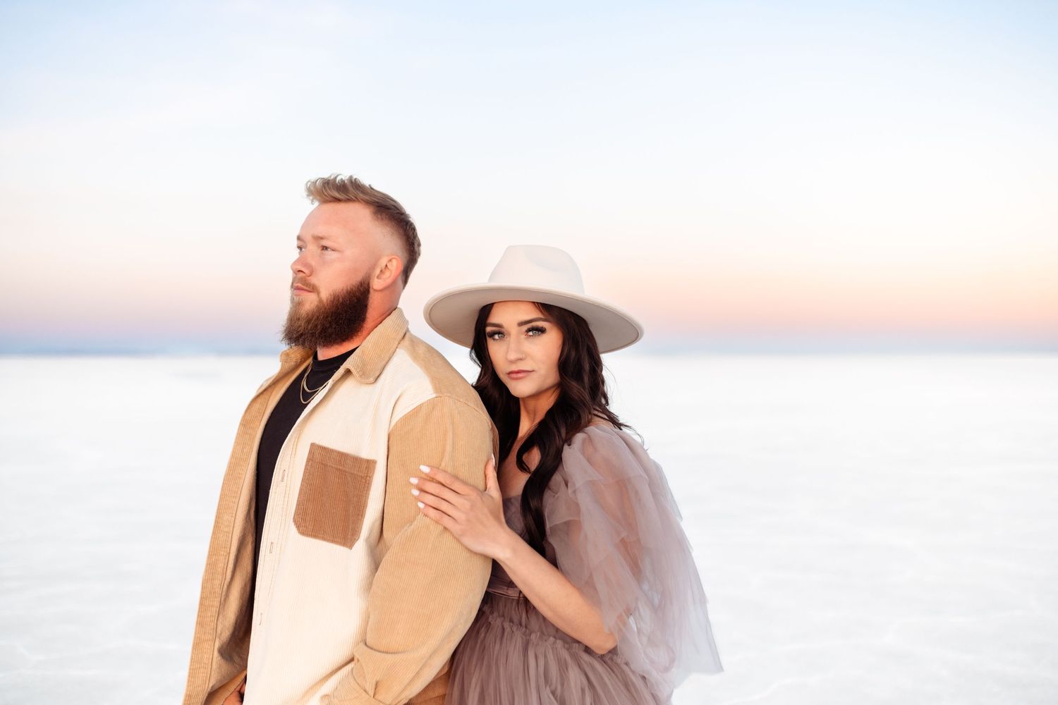 Couple hold each other during Salt Flats photos by Utah couples photographer during sunset